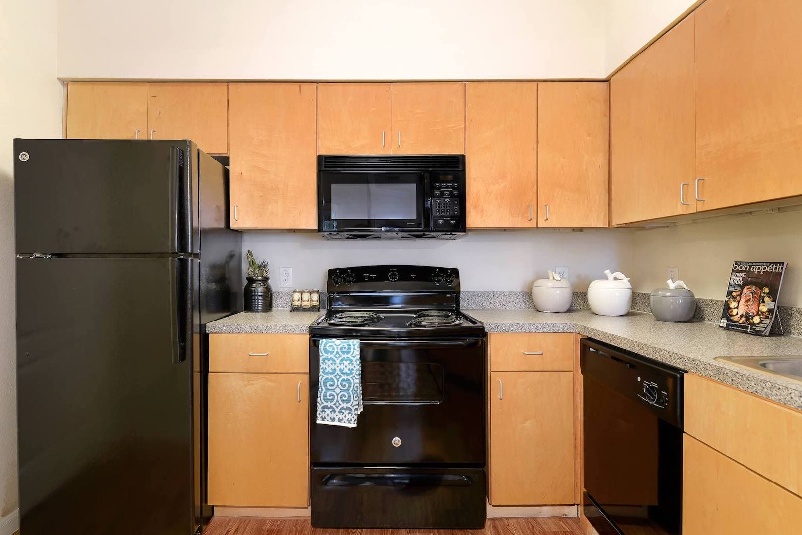 kitchen with black appliances and brown cabinetry