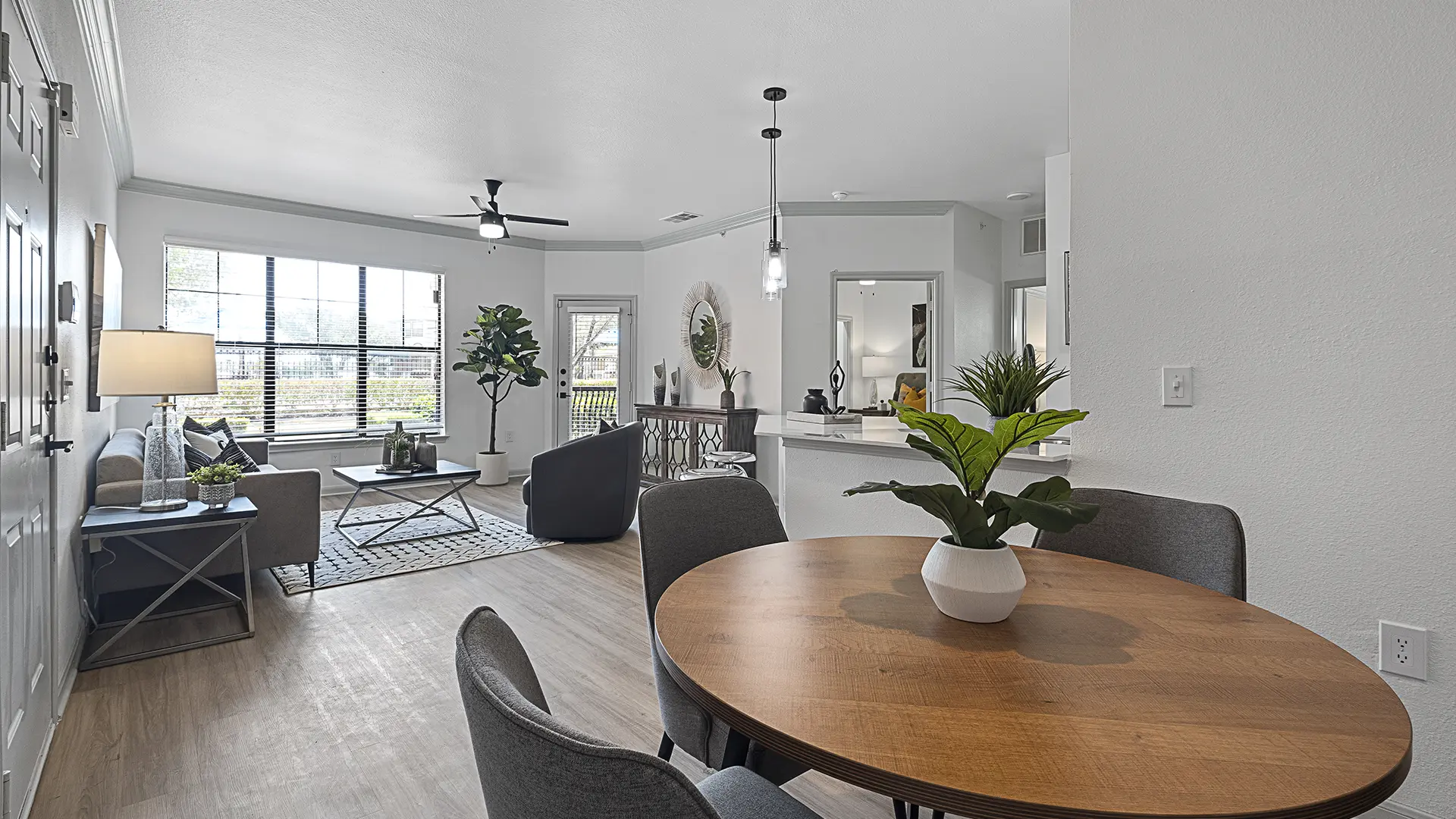 dining room and living room with modern furniture looking towards window, patio and bedroom