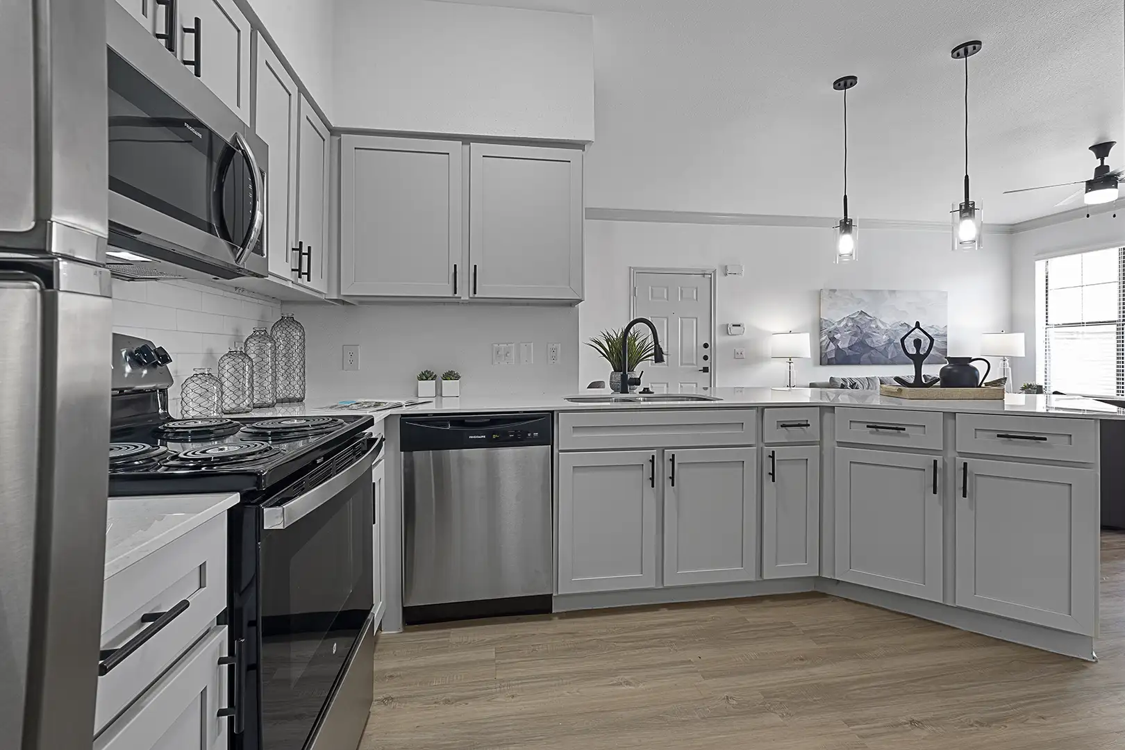 model kitchen with plank flooring looking towards front door