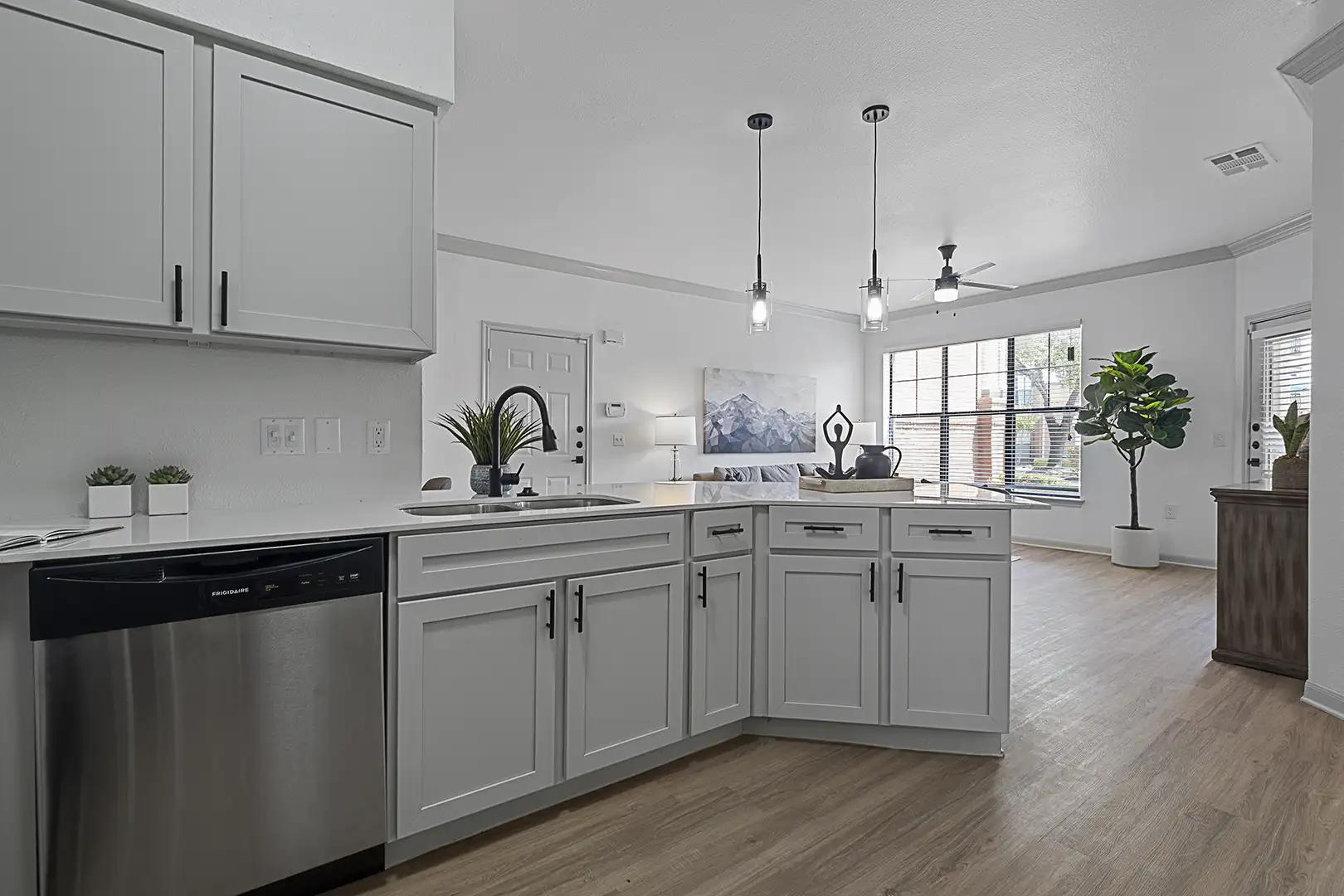 model kitchen looking towards living room with ample lighting